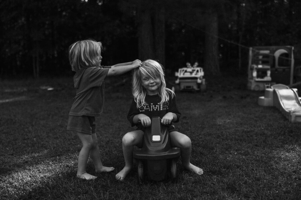 s young siblings playing outside