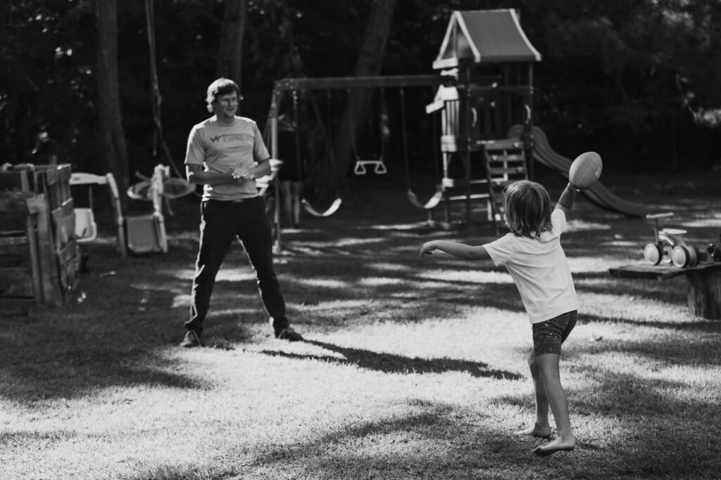 a father and son playing catch from a family documentary session